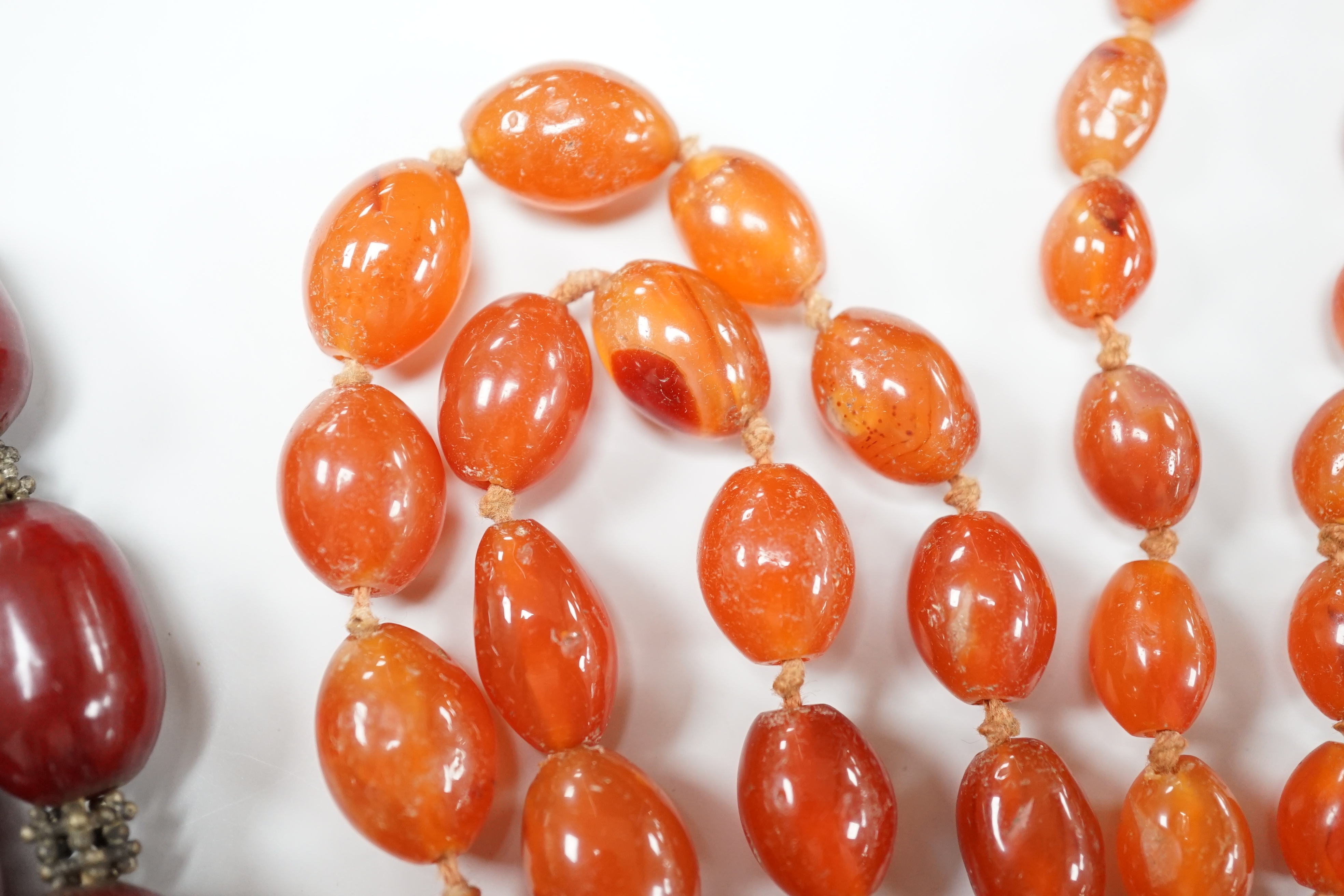 A simulated graduated red amber bead necklace, 52cm and an orange agate bead necklace, 92cm